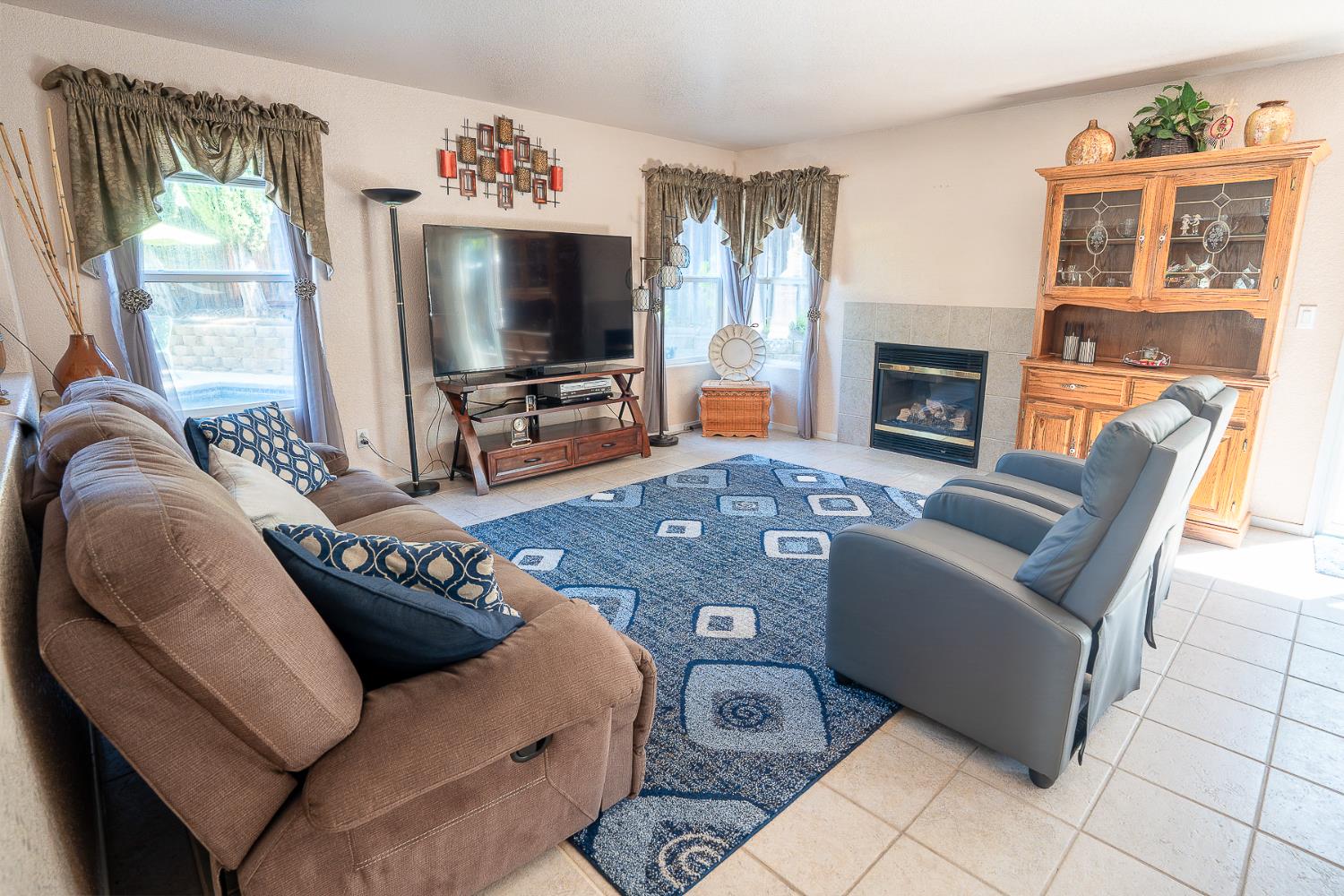 4237 Narraganset Way Mather, CA 95655 - Photo 4 of 40 a living room with furniture a flat screen tv and a fireplace