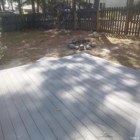 a view of backyard with wooden fence
