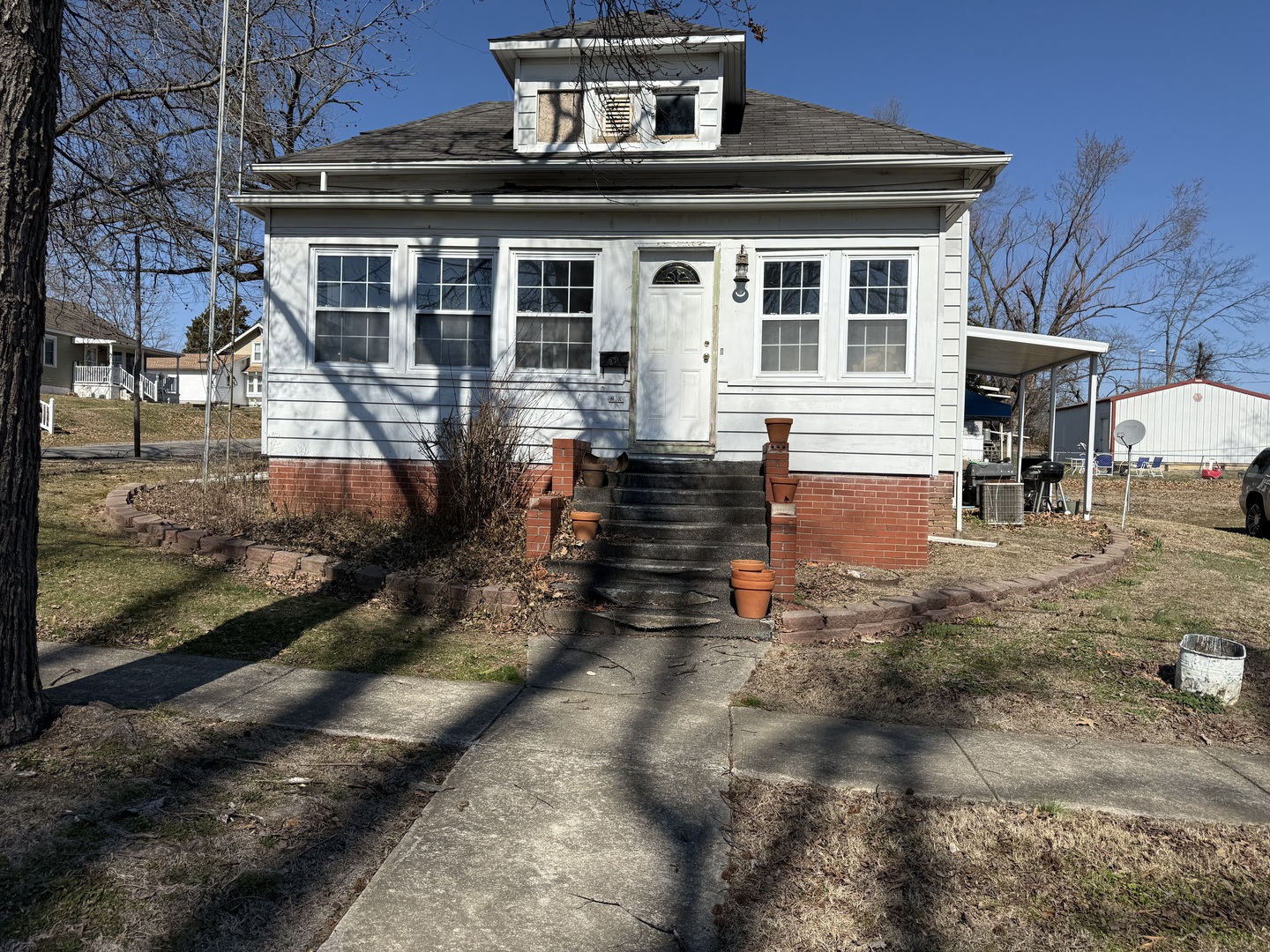 2000 1st Street Eldorado, IL 62930 - Photo 1 of 19 a view of a white house with large windows next to a yard