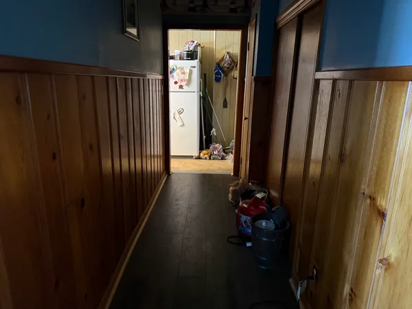 a view of a hallway with wooden floor