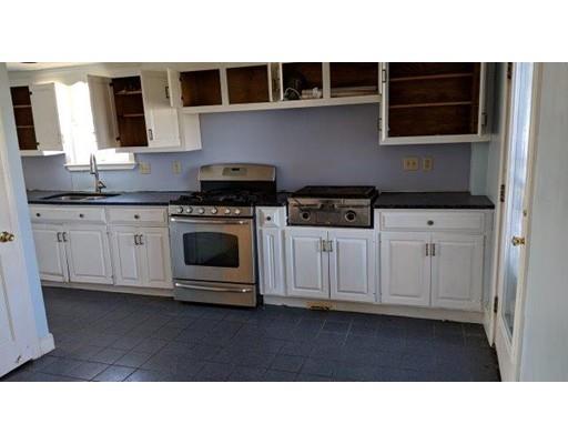 145 Jericho Road Scituate, MA 02066 - Photo 5 of 14 a kitchen with stainless steel appliances kitchen island granite countertop a stove a sink and a microwave