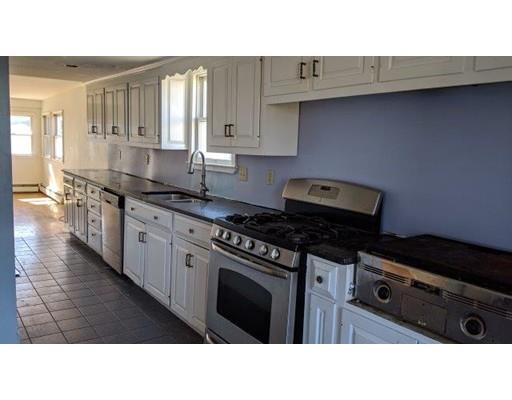 145 Jericho Road Scituate, MA 02066 - Photo 6 of 14 a kitchen with stainless steel appliances a stove a sink and cabinets