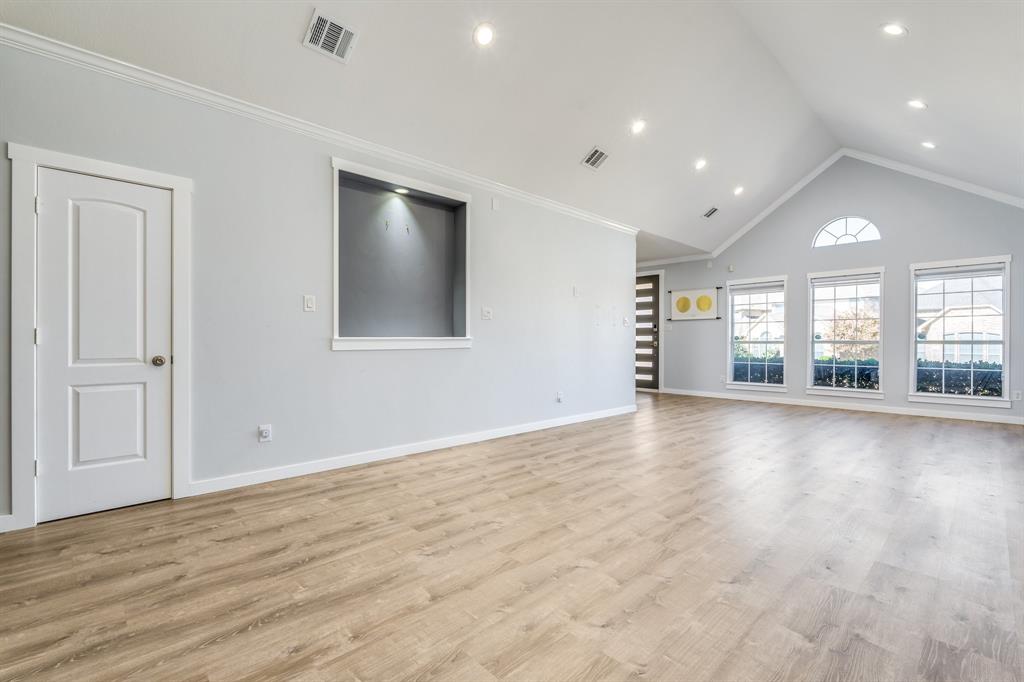 2300 Janna Way Carrollton, TX 75006 - Photo 11 of 40 a view of an empty room with wooden floor and a window