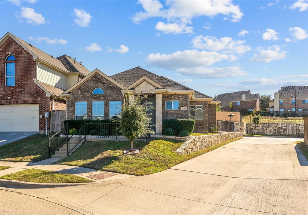 2300 Janna Way Carrollton, TX 75006 - Photo 2 of 40 a view of a white house with a large tree and plants