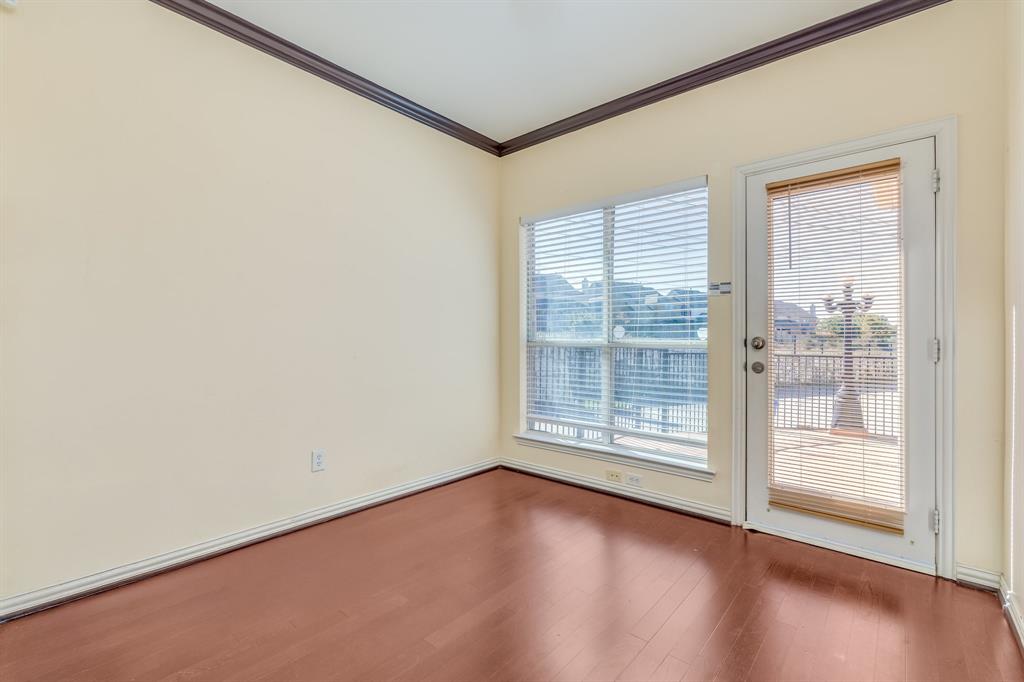 2300 Janna Way Carrollton, TX 75006 - Photo 23 of 40 an empty room with wooden floor and windows