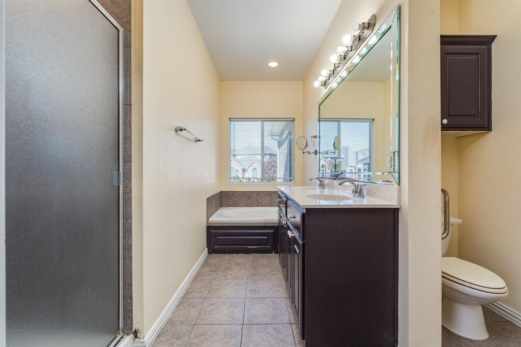 2300 Janna Way Carrollton, TX 75006 - Photo 27 of 40 a bathroom with a sink a toilet and a mirror
