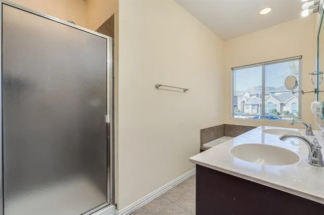 a bathroom with a sink a large mirror and a bathtub