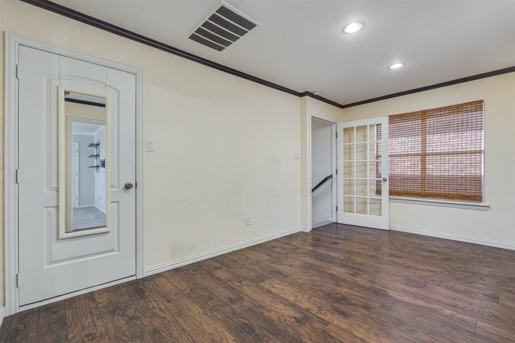 2300 Janna Way Carrollton, TX 75006 - Photo 33 of 40 an empty room with wooden floor and windows