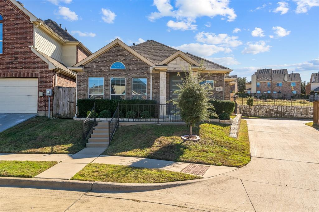 2300 Janna Way Carrollton, TX 75006 - Photo 4 of 40 a front view of a house with garden
