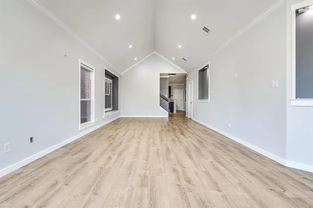 a view of empty room with wooden floor