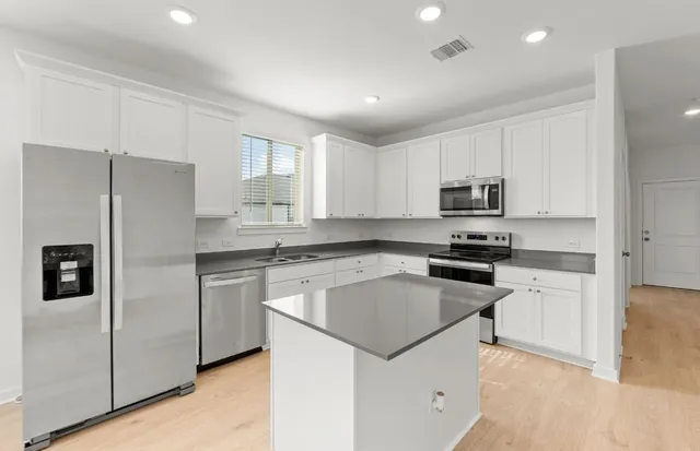 a kitchen with granite countertop a stove and a sink