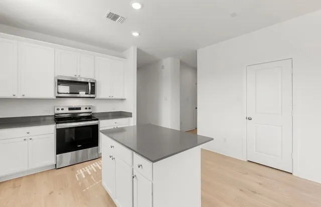 an empty room with windows and closet