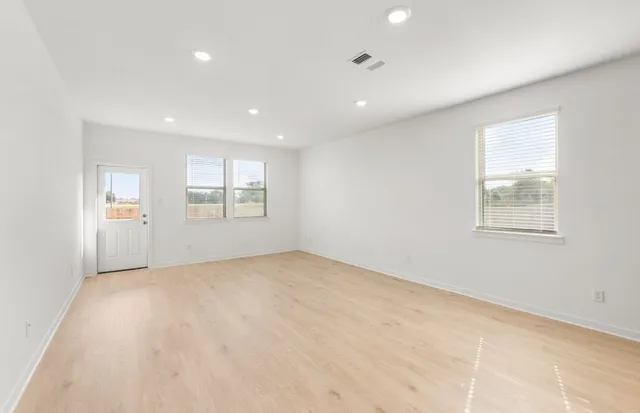 a view of an empty room with a kitchen