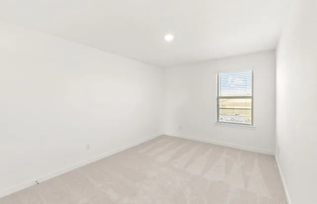 a view of an empty room and a window