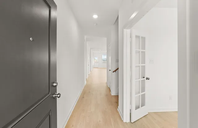 a view of a hallway with wooden floor