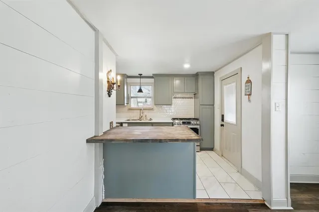 a kitchen with stainless steel appliances granite countertop a sink and cabinets