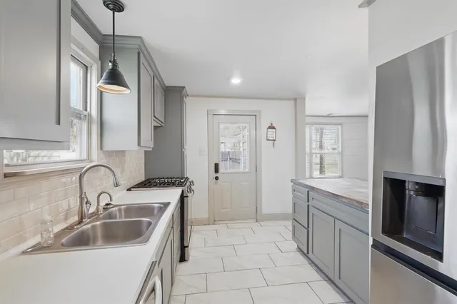 a kitchen with a sink cabinets and stainless steel appliances