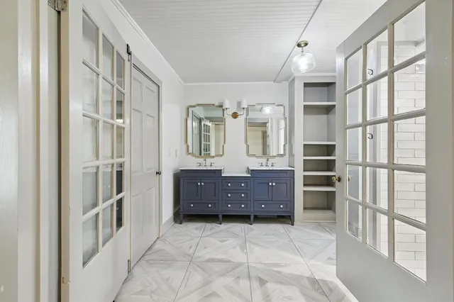 a spacious bathroom with a double vanity sink and a mirror
