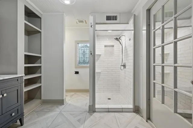 a spacious bathroom with a granite countertop sink a mirror and a shower