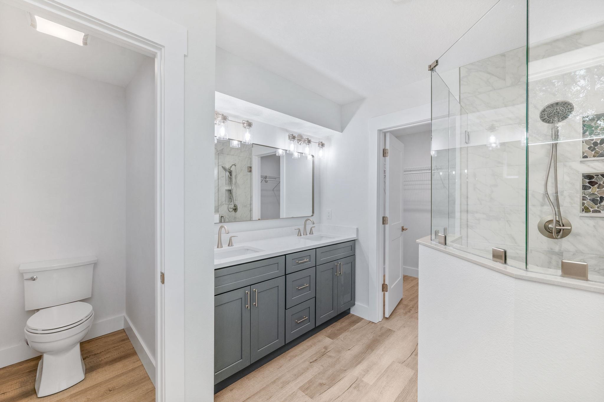 6132 Highway 1 St. Augustine, FL 32086 - Photo 17 of 55 a bathroom with a granite countertop sink a toilet and shower
