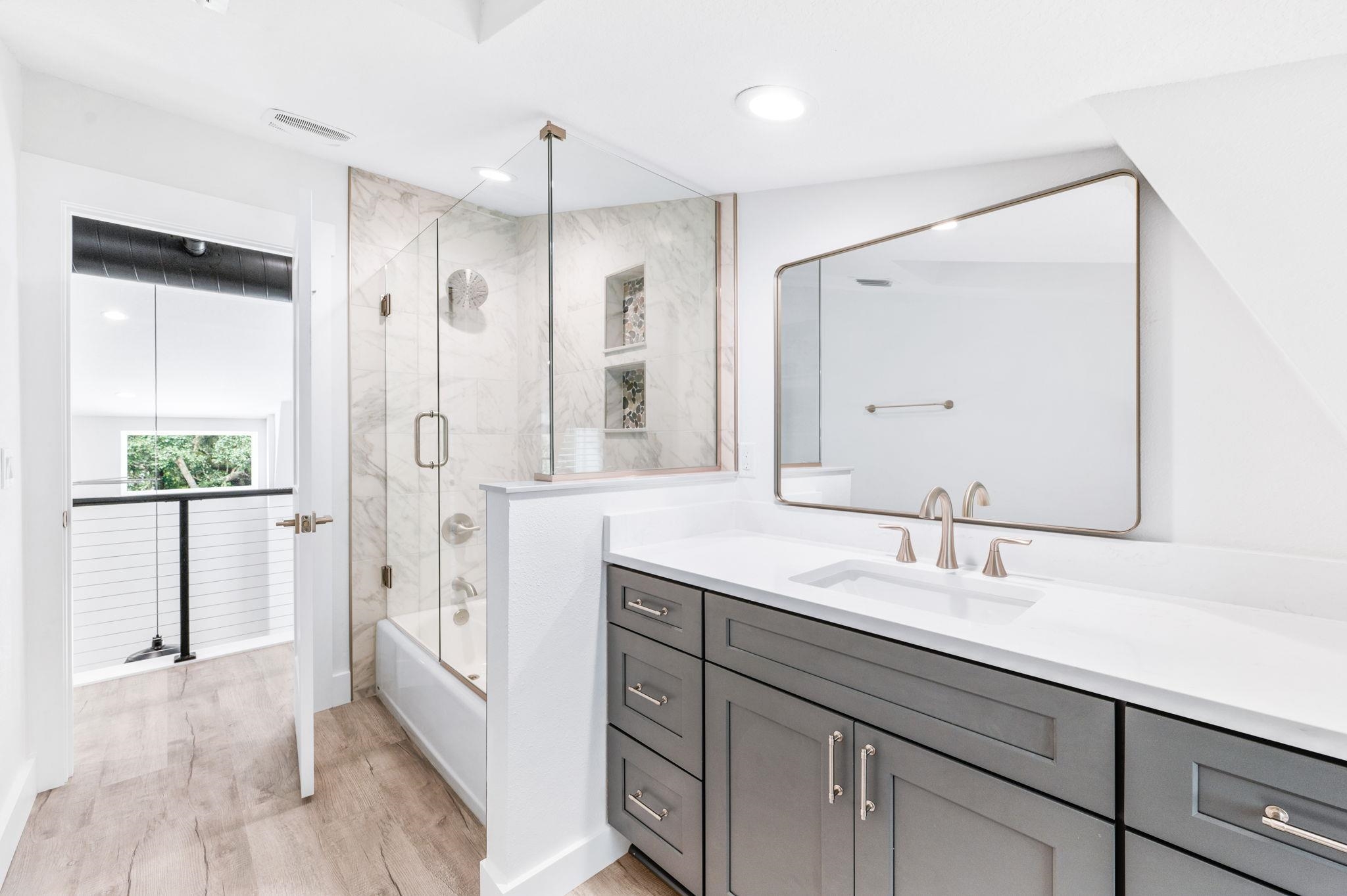 6132 Highway 1 St. Augustine, FL 32086 - Photo 35 of 55 a bathroom with a shower sink vanity and mirror
