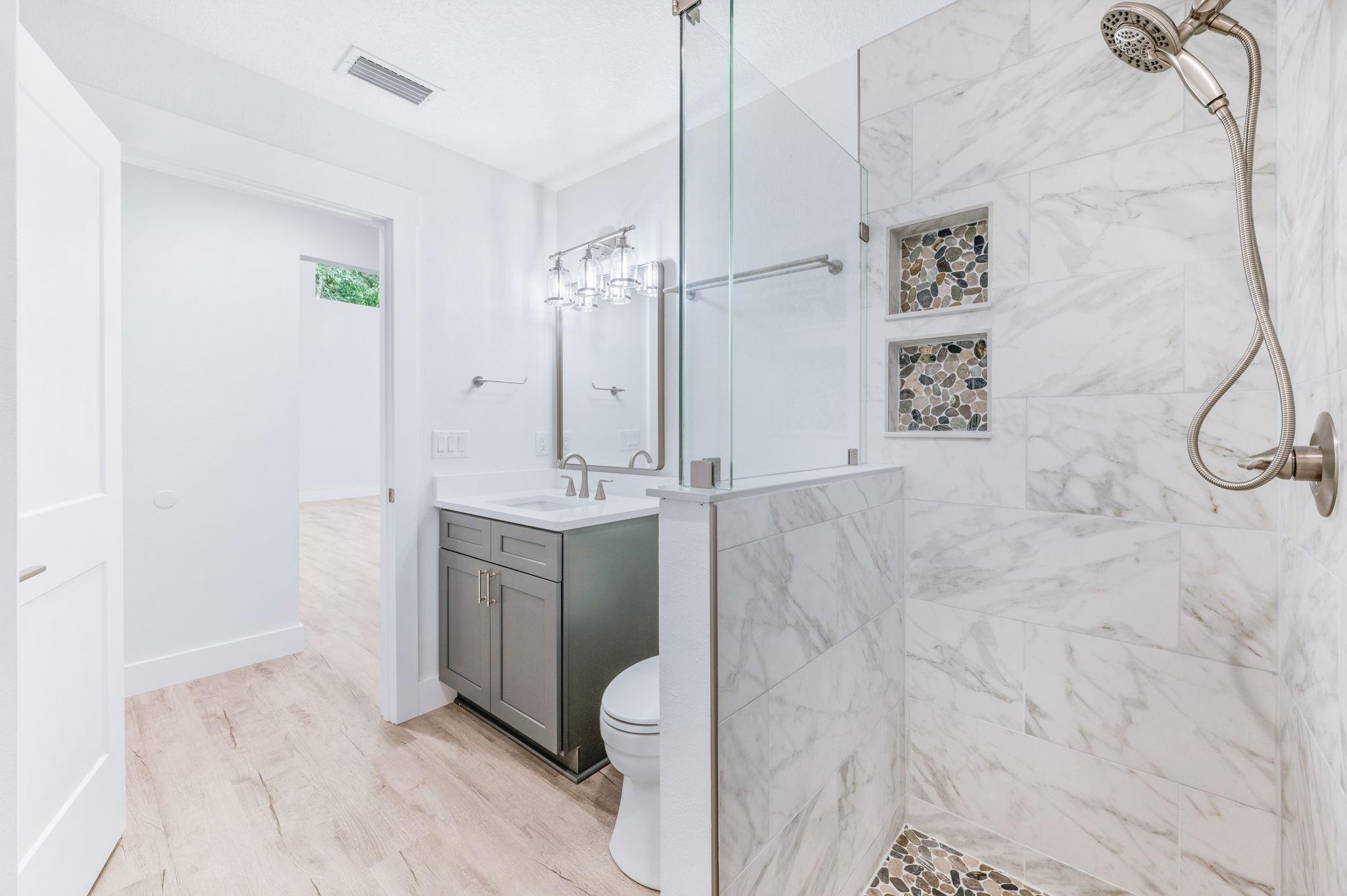 6132 Highway 1 St. Augustine, FL 32086 - Photo 39 of 55 a bathroom with a granite countertop sink a vanity and shower