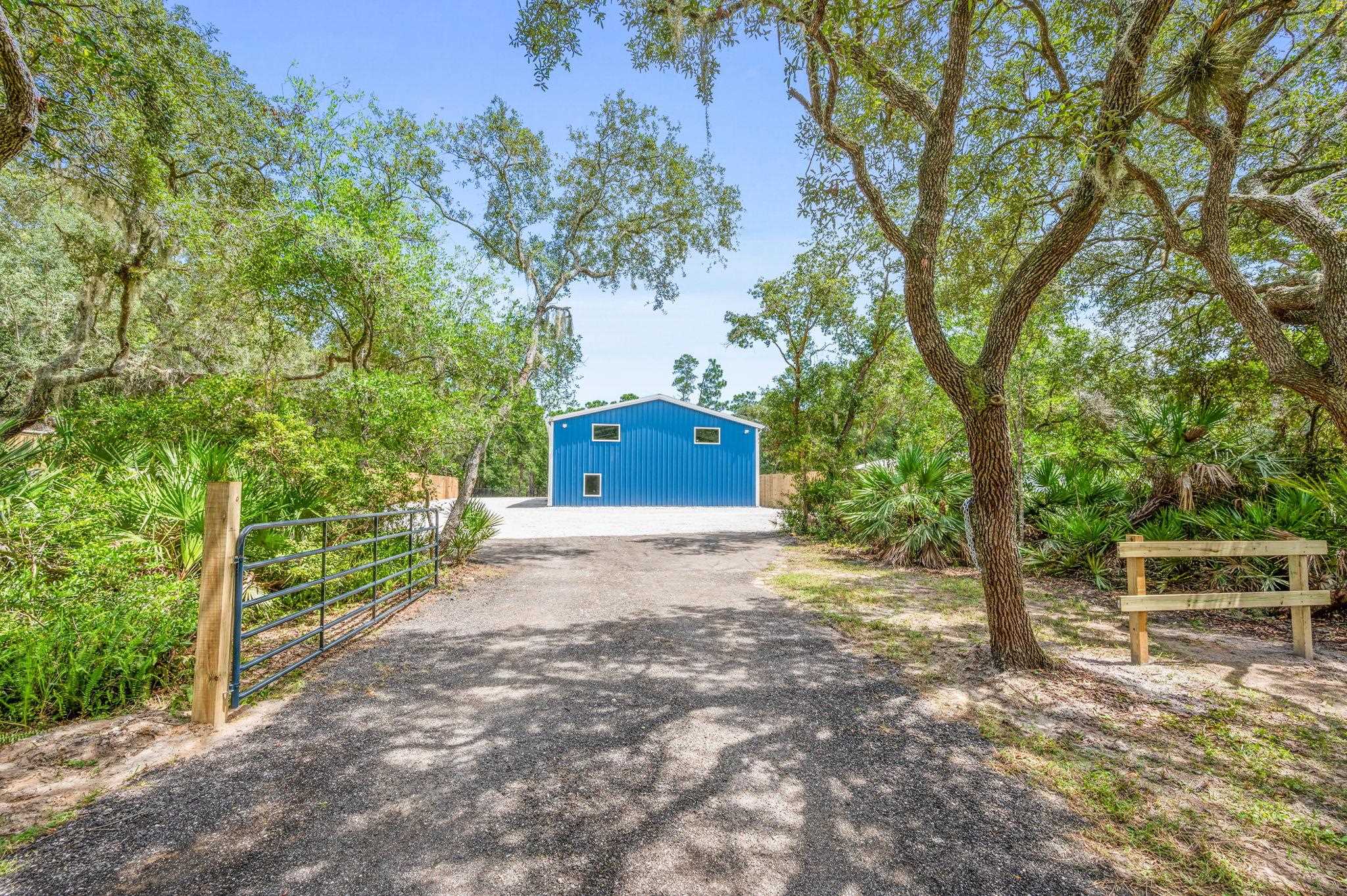 6132 Highway 1 St. Augustine, FL 32086 - Photo 4 of 55 a front view of a house with a yard