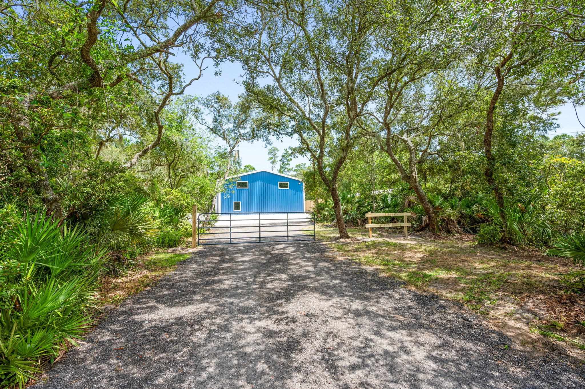 6132 Highway 1 St. Augustine, FL 32086 - Photo 52 of 55 Shaded driveway with gate for added security and privacy