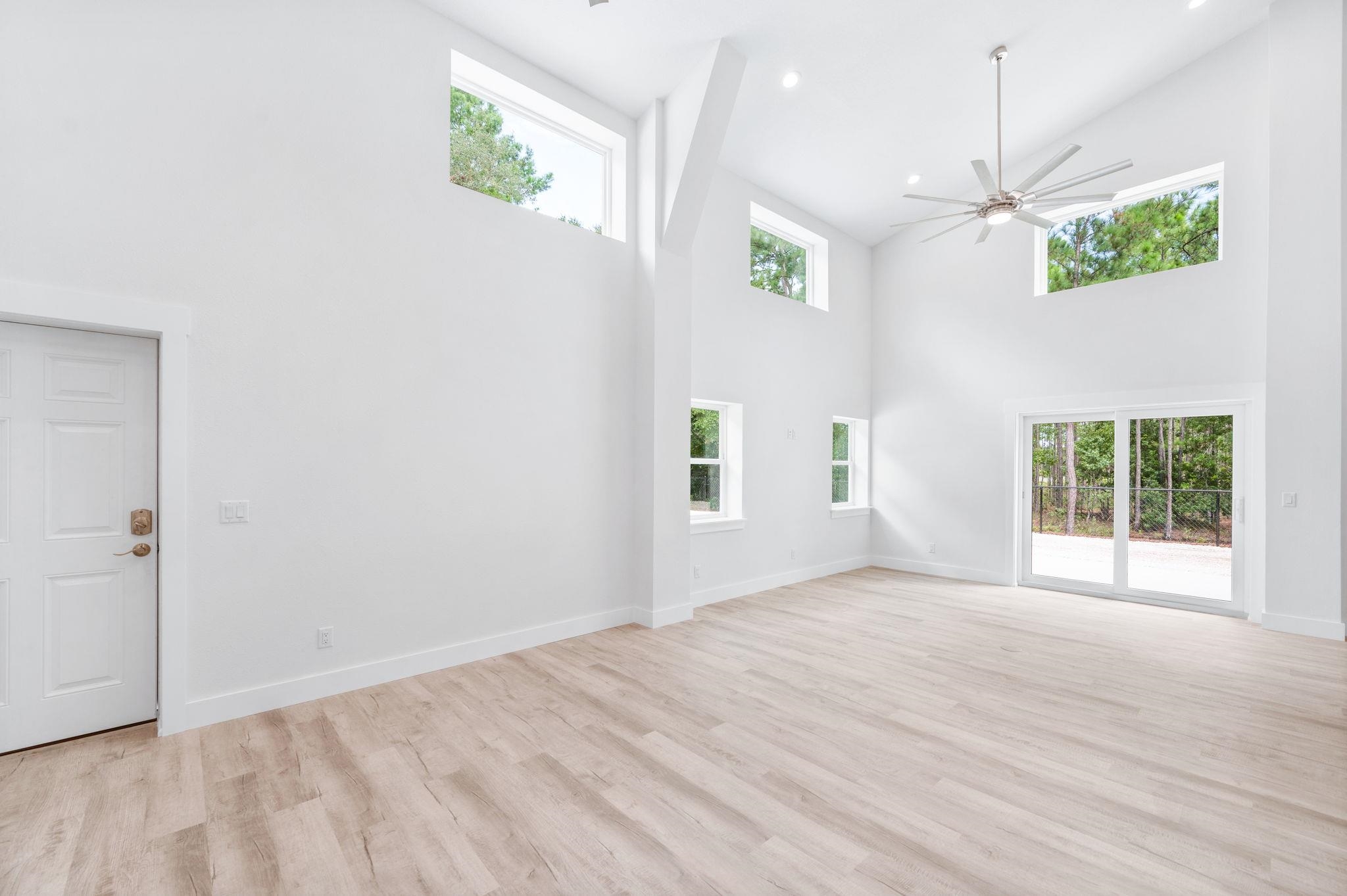 6132 Highway 1 St. Augustine, FL 32086 - Photo 7 of 55 an empty room with windows and ceiling fan