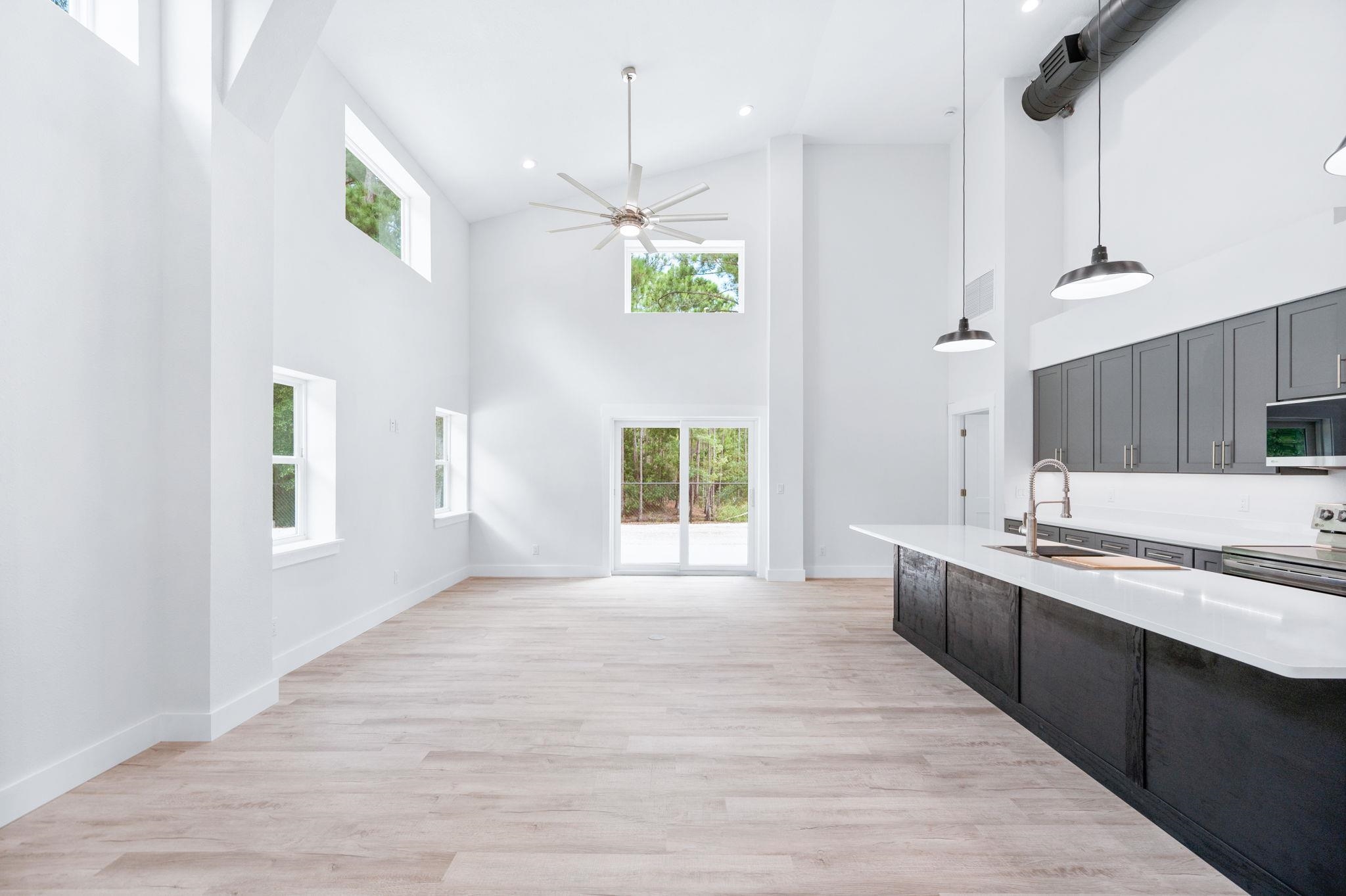 6132 Highway 1 St. Augustine, FL 32086 - Photo 8 of 55 a large kitchen with kitchen island a window a wooden floor and a sink