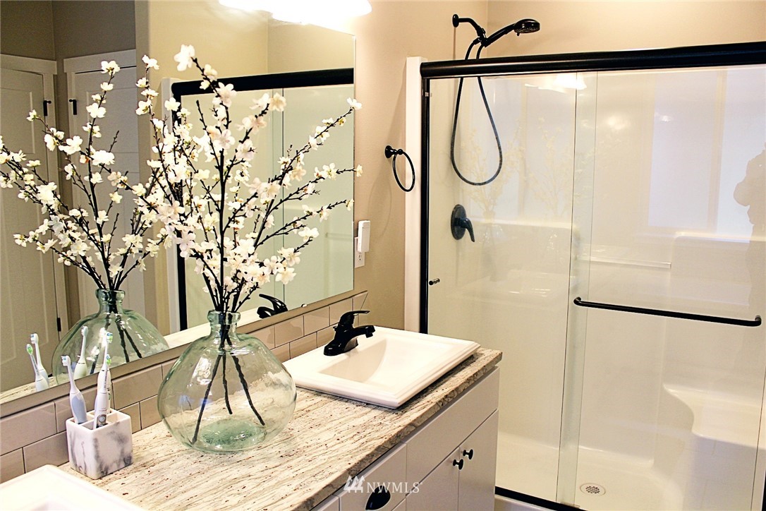 17325 Littlerock Road Southwest Rochester, WA 98579 - Photo 14 of 20 a bathroom with a granite countertop sink and a mirror