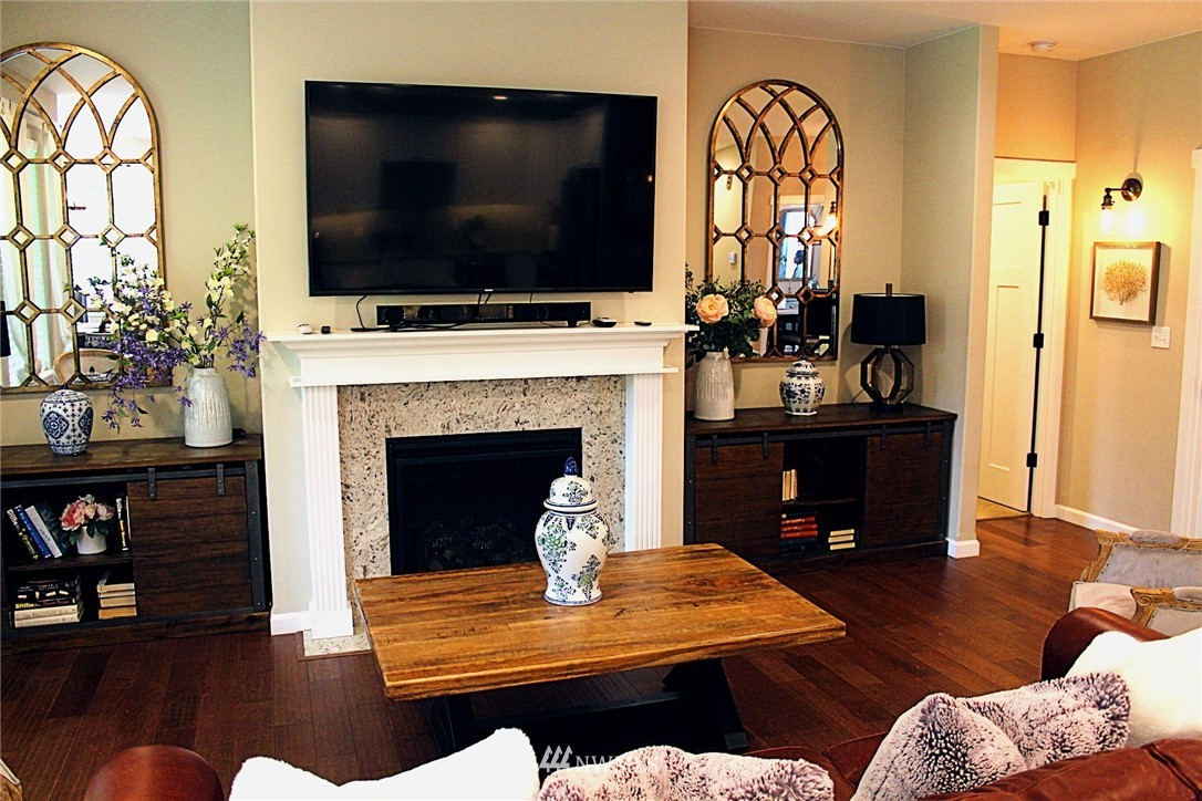 17325 Littlerock Road Southwest Rochester, WA 98579 - Photo 4 of 20 a living room with furniture a flat screen tv and a fireplace