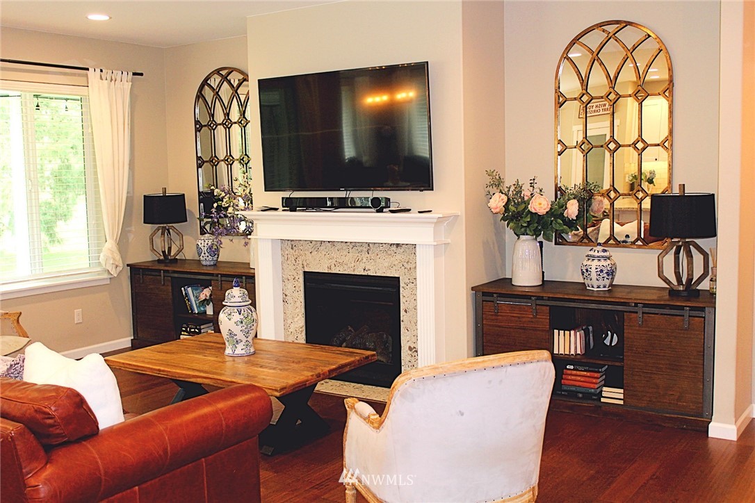 17325 Littlerock Road Southwest Rochester, WA 98579 - Photo 5 of 20 a living room with furniture a flat screen tv and a fireplace