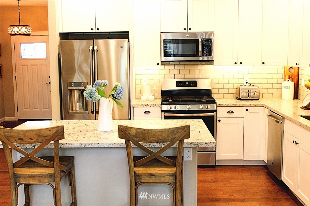 17325 Littlerock Road Southwest Rochester, WA 98579 - Photo 9 of 20 a kitchen with a stove a sink and a microwave