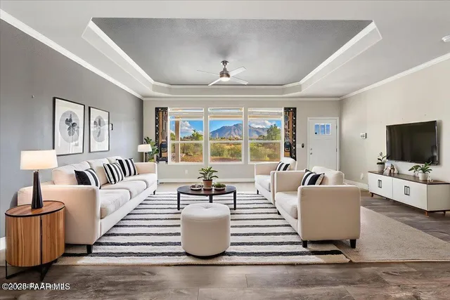 a living room with furniture a flat screen tv and a large window