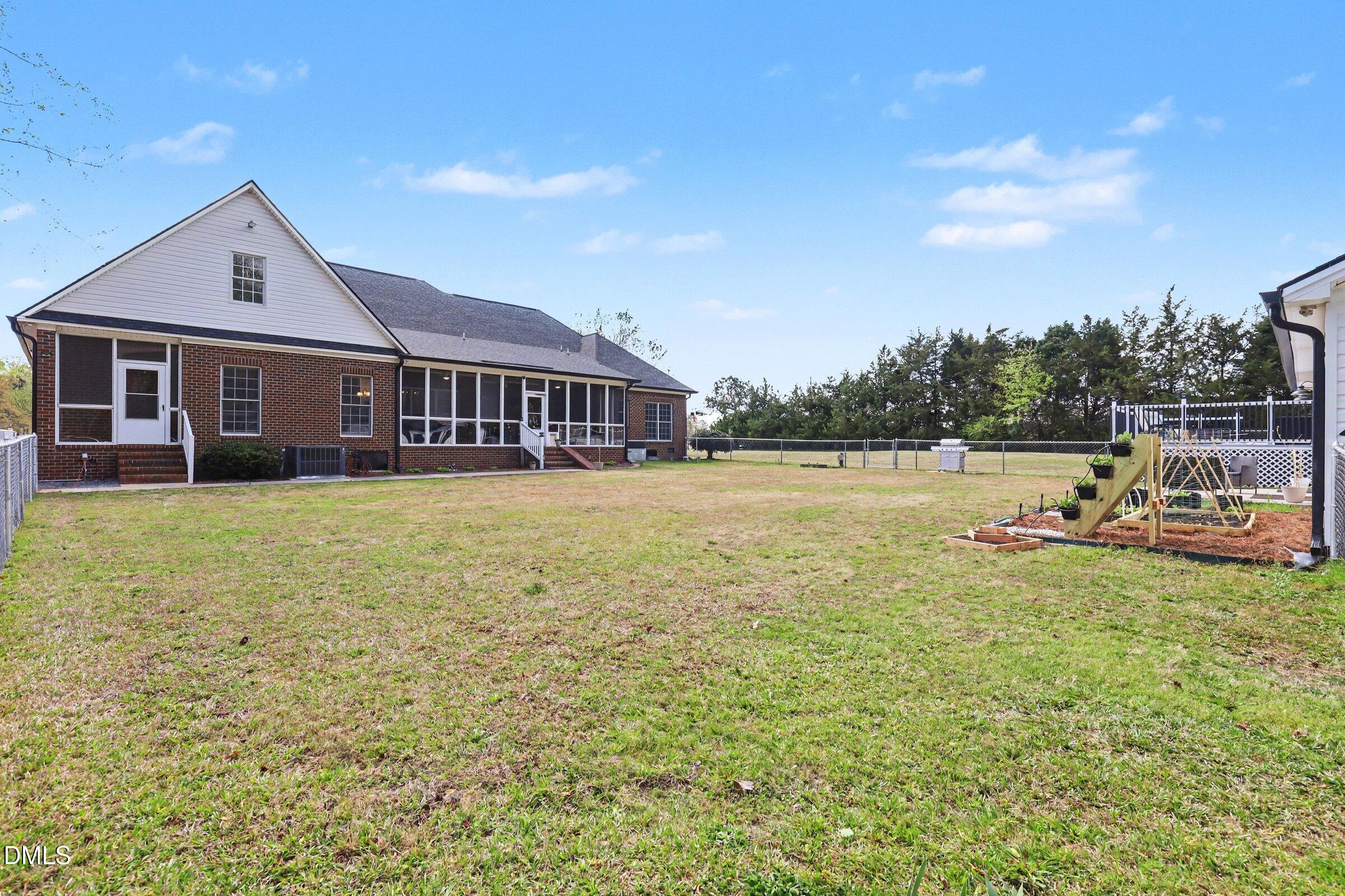430 Fred Hall Road Stedman, NC 28391 - Photo 31 of 63 a view of a house with patio and a yard