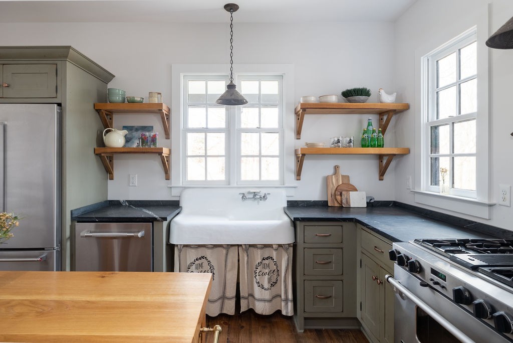 5184 Fire Tower Road Franklin, TN 37064 - Photo 15 of 70 a kitchen with stainless steel appliances granite countertop a sink stove and refrigerator