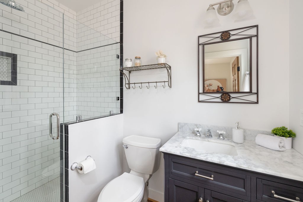 5184 Fire Tower Road Franklin, TN 37064 - Photo 28 of 70 a bathroom with a granite countertop toilet sink and mirror