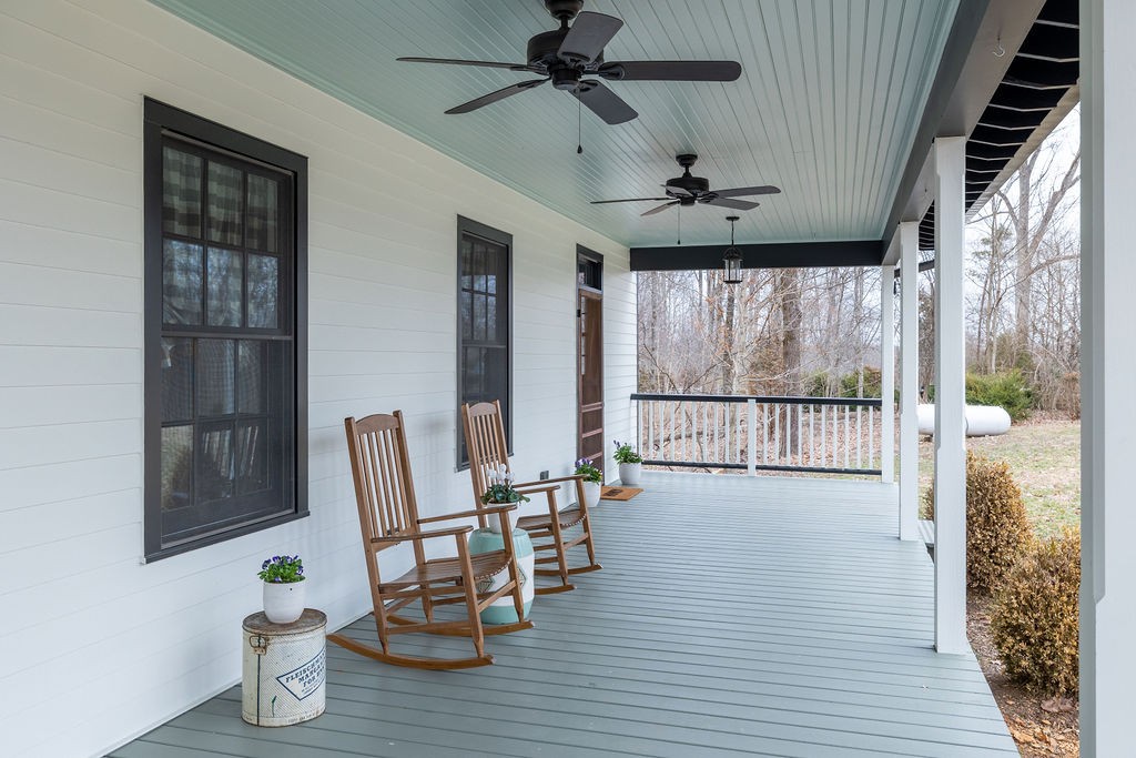 5184 Fire Tower Road Franklin, TN 37064 - Photo 3 of 70 a dining room with wooden floor a chandelier a glass table and chairs