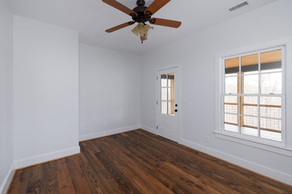 5184 Fire Tower Road Franklin, TN 37064 - Photo 37 of 70 an empty room with wooden floor fan and windows