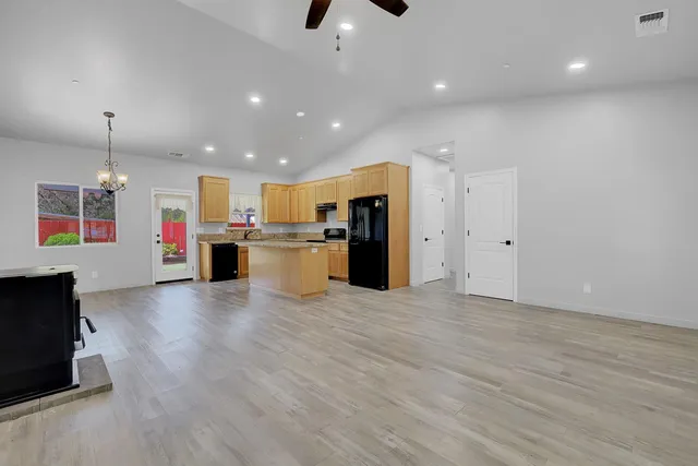 a kitchen with granite countertop cabinets stainless steel appliances and a counter space