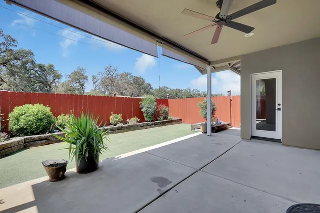 a backyard of a house with table and chairs