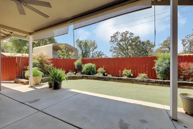 a view of a house with wooden fence