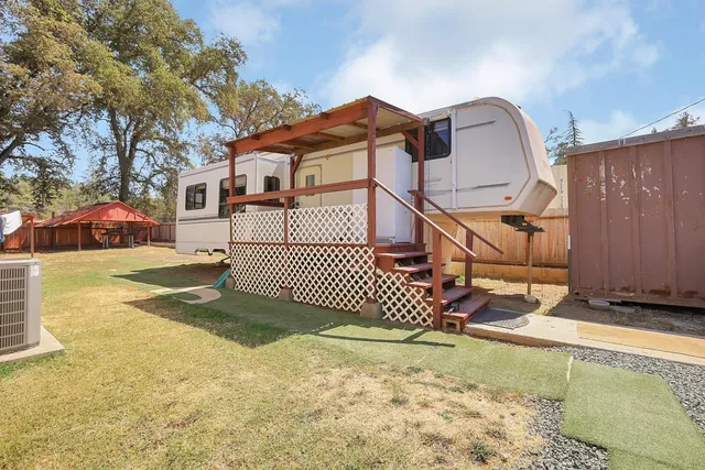 a backyard of a house with table and chairs