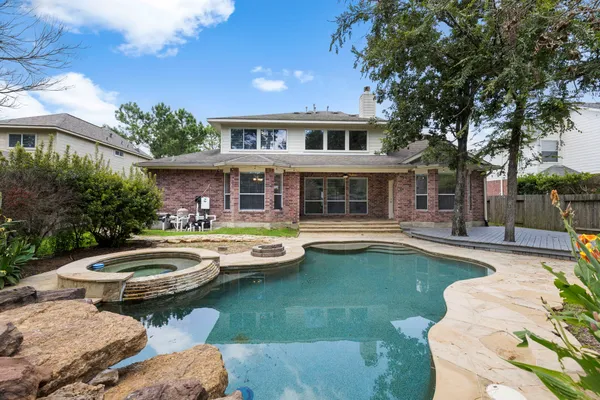 a view of swimming pool with outdoor seating and a garden
