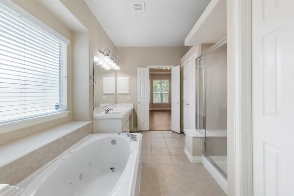 a bathroom with a bathtub toilet and shower