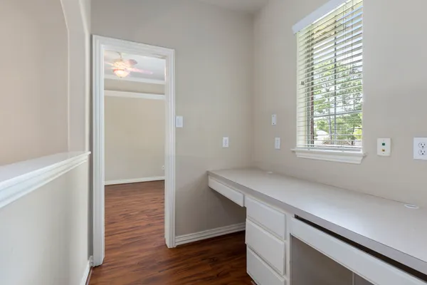 a room with a wooden floor and a window