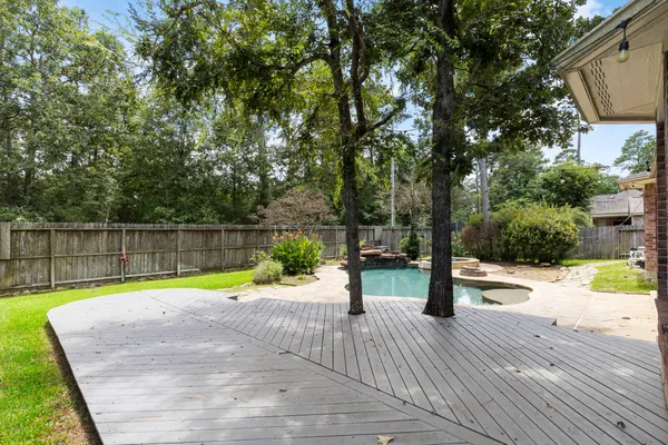 a view of swimming pool with a patio and lake view