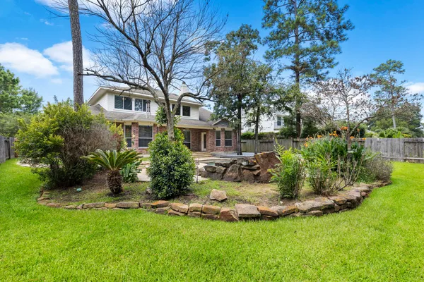 a view of a house with a yard and sitting area