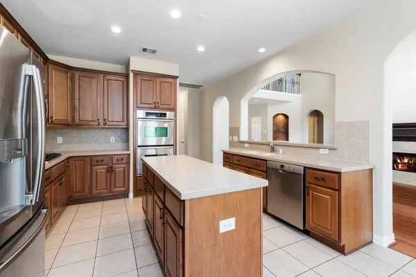 a kitchen with stainless steel appliances granite countertop a stove and a sink